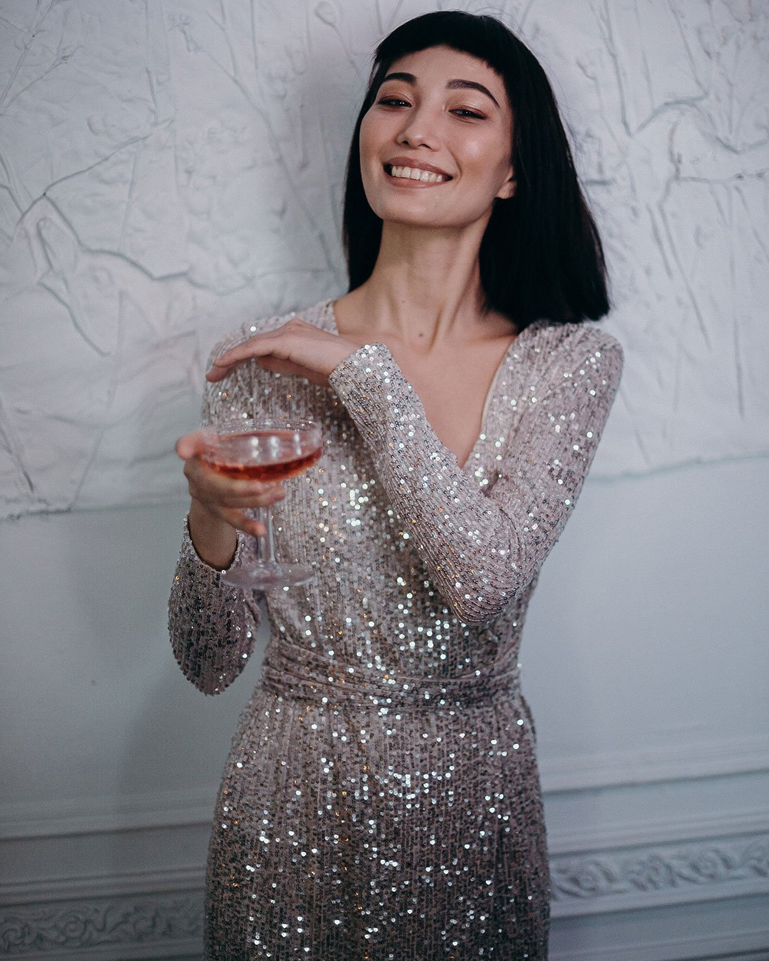 photo-of-woman-wearing-silver-dress-while-holding-cocktail-3402700